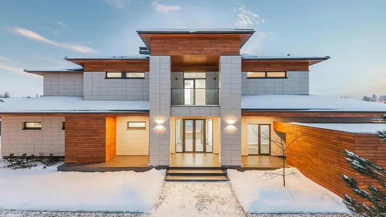 Modern flat-roof family home in winter, the kind of residence at issue in Medicaid estate recovery and elder law planning